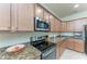 Modern kitchen with granite countertops and stainless steel appliances at 6512 Willowshire Way, Bradenton, FL 34212