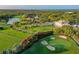 Aerial view of golf course, clubhouse, and surrounding area at 654 Trenton Way, Osprey, FL 34229