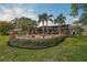 Landscaped backyard with fire pit and view of home at 654 Trenton Way, Osprey, FL 34229