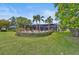 Landscaped backyard with fire pit and pool at 654 Trenton Way, Osprey, FL 34229