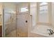 Spa-like bathroom with a large walk-in shower and an oval soaking tub at 654 Trenton Way, Osprey, FL 34229