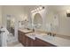 Double vanity bathroom with granite countertops and oval mirrors at 654 Trenton Way, Osprey, FL 34229