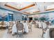 Elegant dining room with scenic mural and white tablecloths at 654 Trenton Way, Osprey, FL 34229