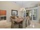 Elegant dining room with chandelier and seating for six at 654 Trenton Way, Osprey, FL 34229