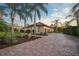 Brick paver driveway leading to a three car garage at 654 Trenton Way, Osprey, FL 34229