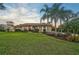 Well-maintained lawn and landscaping with palm trees at 654 Trenton Way, Osprey, FL 34229