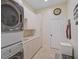 Bright laundry room with washer, dryer, and ample cabinet space at 654 Trenton Way, Osprey, FL 34229