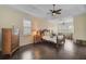 Main bedroom with dark hardwood floors, a king-size bed, and plenty of natural light at 654 Trenton Way, Osprey, FL 34229