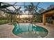 Inviting freeform pool and spa with covered patio and sunset views at 654 Trenton Way, Osprey, FL 34229