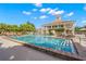 Community pool with adjacent clubhouse and lounge chairs at 654 Trenton Way, Osprey, FL 34229