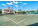 Tennis court with clubhouse in background at 654 Trenton Way, Osprey, FL 34229