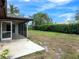 Home's backyard with screened porch and expansive grassy area at 6770 Mauna Loa Blvd, Sarasota, FL 34241