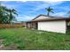 Large backyard with grassy area and wooden fence, showcasing home's exterior at 6770 Mauna Loa Blvd, Sarasota, FL 34241