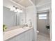 Bright bathroom features a large mirror, a plant and walk-in shower at 6770 Mauna Loa Blvd, Sarasota, FL 34241