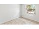 Empty bedroom with tile flooring and a window offering a view of the street at 6770 Mauna Loa Blvd, Sarasota, FL 34241