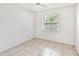 Small bedroom with tile floor and window with blinds at 6770 Mauna Loa Blvd, Sarasota, FL 34241