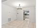 Dining room with tile floors, chandelier, and view of the kitchen at 6770 Mauna Loa Blvd, Sarasota, FL 34241