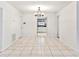 An open-concept dining room featuring tile flooring, a modern chandelier, and an adjacent updated kitchen at 6770 Mauna Loa Blvd, Sarasota, FL 34241