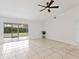 Bright living room features tile flooring, neutral walls, and sliding doors to the backyard at 6770 Mauna Loa Blvd, Sarasota, FL 34241