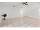 Living room featuring tile floors, a ceiling fan, and access to backyard at 6770 Mauna Loa Blvd, Sarasota, FL 34241