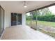 Covered back patio featuring tile flooring and views of the grassy yard with privacy landscaping at 6770 Mauna Loa Blvd, Sarasota, FL 34241