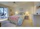 Cozy bedroom with a queen-size bed and access to balcony at 6800 Placida Rd # 2017, Englewood, FL 34224