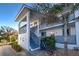 Front view of a two-story building with stairs and bicycle at 6800 Placida Rd # 2017, Englewood, FL 34224