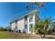 Exterior view of condo building showcasing a light-grey building with a balcony at 6800 Placida Rd # 2017, Englewood, FL 34224