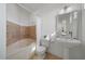 Elegant bathroom with soaking tub and pedestal sink at 6919 Winners Cir, Lakewood Ranch, FL 34202