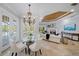 Casual breakfast nook with glass table and French doors leading to the pool at 6919 Winners Cir, Lakewood Ranch, FL 34202