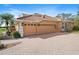 Three-car garage with a paver driveway and mature landscaping at 6919 Winners Cir, Lakewood Ranch, FL 34202