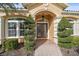 Inviting entryway with double doors and well-maintained landscaping at 6919 Winners Cir, Lakewood Ranch, FL 34202