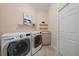 Laundry room with LG washer and dryer, utility sink, and ample storage at 6919 Winners Cir, Lakewood Ranch, FL 34202