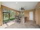 Covered outdoor kitchen with a stone bar and seating at 6919 Winners Cir, Lakewood Ranch, FL 34202