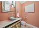 Elegant powder room with a vessel sink and decorative mirror at 6919 Winners Cir, Lakewood Ranch, FL 34202