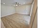 Bright bedroom with wood-look floors and ceiling fan at 7 Oakland Hills Pl, Rotonda West, FL 33947