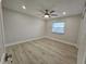 Bright bedroom featuring wood-look floors and ceiling fan at 7 Oakland Hills Pl, Rotonda West, FL 33947