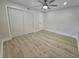 Spacious bedroom with double door closet and wood-look floors at 7 Oakland Hills Pl, Rotonda West, FL 33947