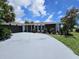 Updated single-story home with a landscaped yard and attached garage at 7 Oakland Hills Pl, Rotonda West, FL 33947