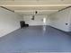 Spacious garage with painted floor and ample storage shelving at 7 Oakland Hills Pl, Rotonda West, FL 33947