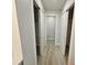 Hallway with double door closets and wood-look floors at 7 Oakland Hills Pl, Rotonda West, FL 33947