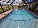 Inviting screened pool with clear water and surrounding patio at 7 Oakland Hills Pl, Rotonda West, FL 33947