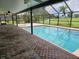 Enclosed pool area with brick pavers and a view of the golf course at 7 Oakland Hills Pl, Rotonda West, FL 33947