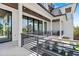 Covered balcony with glass doors and metal railing overlooking backyard at 7007 Point Of Rocks Rd, Sarasota, FL 34242