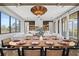 Elegant dining room showcases a long wooden table with seating for eight and a beautiful chandelier at 7007 Point Of Rocks Rd, Sarasota, FL 34242