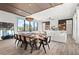 Bright dining room features a large wooden table with seating and large windows at 7007 Point Of Rocks Rd, Sarasota, FL 34242