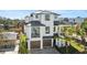 Modern two-story home with dark metal roof and two-car garage at 7007 Point Of Rocks Rd, Sarasota, FL 34242