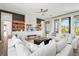 Spacious living room with comfortable white sofas, a built-in entertainment center, and hardwood floors at 7007 Point Of Rocks Rd, Sarasota, FL 34242