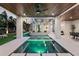 Modern pool and spa area with patio furniture under a wood ceiling at 7007 Point Of Rocks Rd, Sarasota, FL 34242