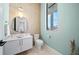 Stylish powder room with modern vanity, toilet, and decorative wall at 7007 Point Of Rocks Rd, Sarasota, FL 34242